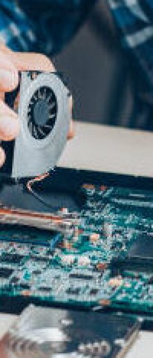 laptop Computer repair service. Hardware support. Electronic technology. Cropped shot of technician fixing laptop cooler.